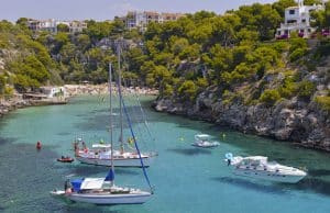 Cala Pi, Mallorca Detalle de Cala Pi, Mallorca con bañistas al fondo y embarcaciones amarradas